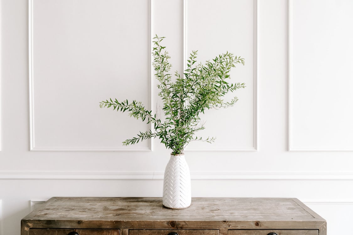 Vase of Leaves on a Table